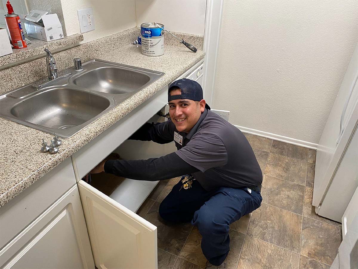 Reymond fixing a plumbing on a sink